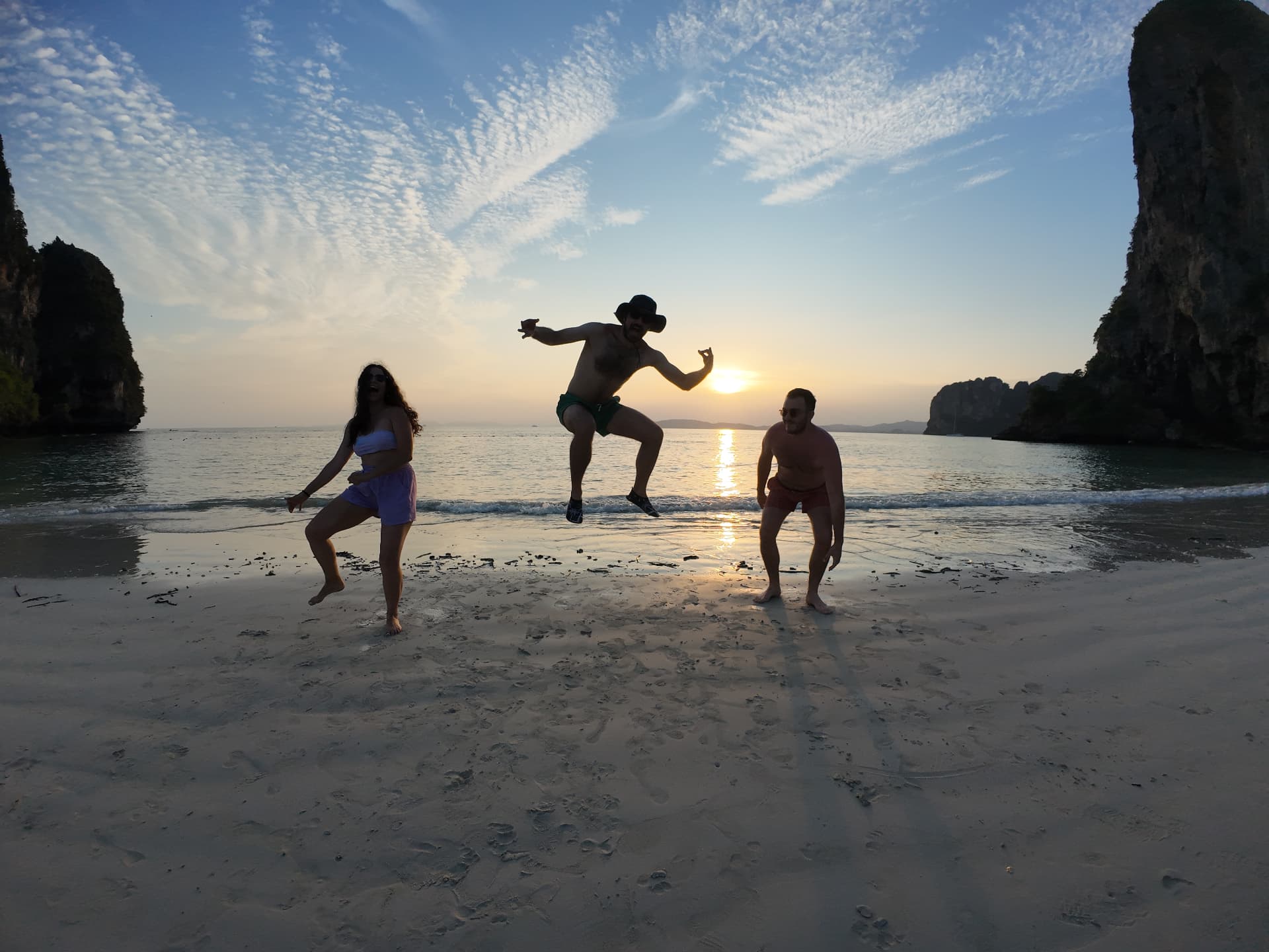 Friends jumping at sunset on a Krabi beach